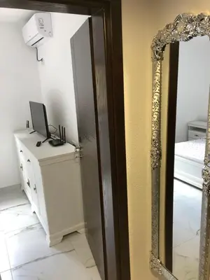 a mirror in a room with a desk and a computer at Apartment Apollo 2 in Kotor