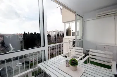 a balcony with a bench and a view of a city at Apartment Terassa in Bar