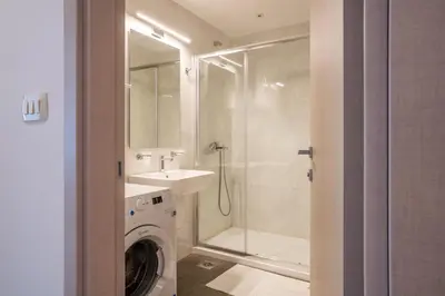 a bathroom with a washing machine and a sink at Fontana Mediteran Properties in Budva