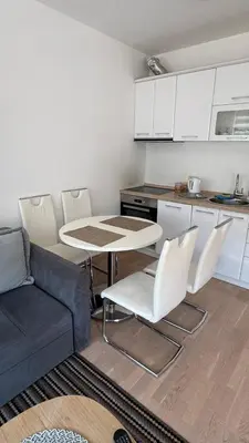 a living room with a couch and a table and chairs at Fontana Mediteran Properties in Budva
