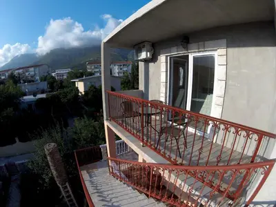 a balcony of a house with a view of a mountain at Apartments Lazarević Sutomore in Sutomore