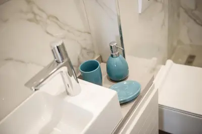 a bathroom with a sink and a blue vase at Palazzo Sindik in Kotor