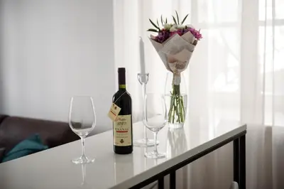 a table with a bottle of wine and two glasses at Palazzo Sindik in Kotor
