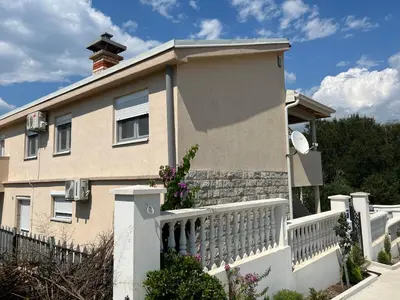 a house with a white fence at NEÐO Apartments Brda in Tivat
