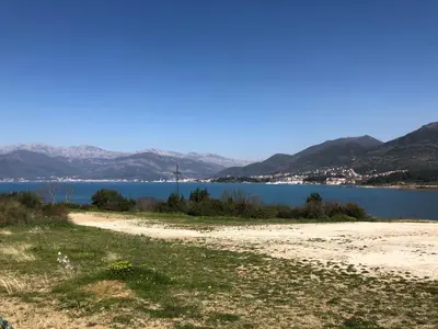 a beach with a view of a body of water at NEÐO Apartments Brda in Tivat
