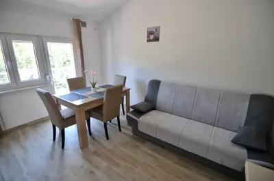a living room with a table and a couch at NEÐO Apartments Brda in Tivat