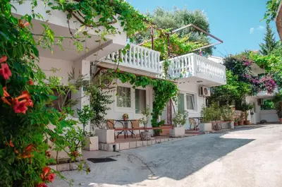 a white house with a lot of plants at Mediterranean Retreat Becici in Becici