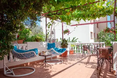 a patio with two chairs and a table and chairs at Mediterranean Retreat Becici in Becici