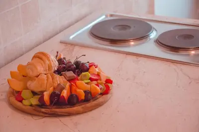a plate of fruit on top of a counter at Mediterranean Retreat Becici in Becici