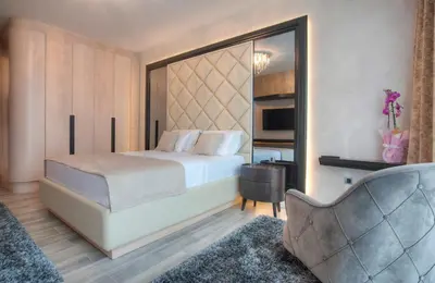 a bedroom with a bed and a chair at Villa Salute in Budva