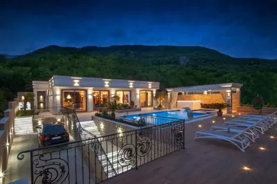 a house with a swimming pool on a deck at Villa Salute in Budva