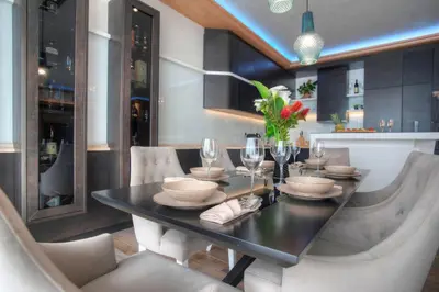 a dining room with a black table and chairs at Villa Salute in Budva
