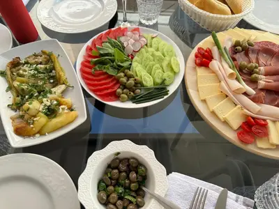 a table with four plates of food on it at Apartments Petar in Budva