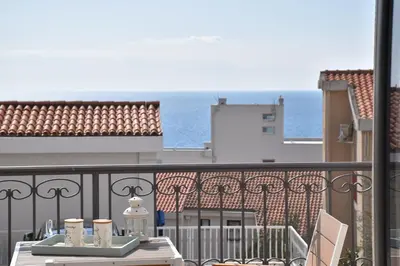 a balcony with a table and a view of the ocean at Apartments Petar in Budva