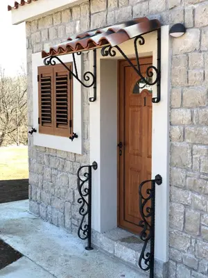 a entrance to a house with a wooden door at Apartments Monte Green in Virpazar