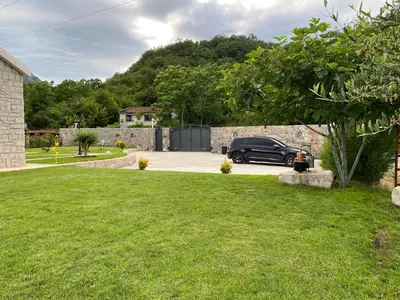 a car parked in the driveway of a house at Apartments Monte Green in Virpazar