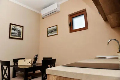 a room with a sink and a table with chairs at Apartments Monte Green in Virpazar