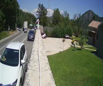 a white car parked on the side of a road at Apartments Monte Green in Virpazar