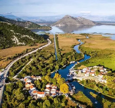 an aerial view of a river and a village at Apartments Monte Green in Virpazar