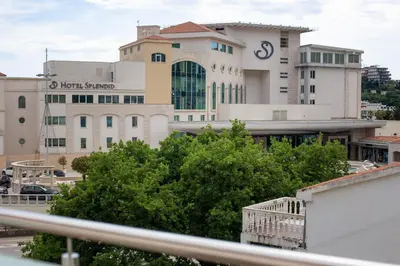a large building in front of a building at Apartmani Becici in Becici