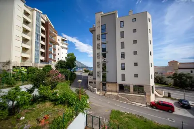 a view of two tall buildings and a street at Apartmani Becici in Becici