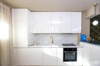 a kitchen with white cabinets and a sink at Villa M&M in Budva
