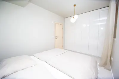a white room with a bed and a window at Villa M&M in Budva