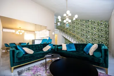 a living room with a green couch and blue pillows at Villa M&M in Budva