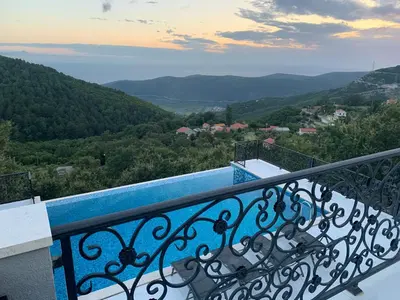 a balcony with a view of the mountains at Villa WOLF in Budva