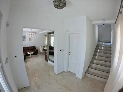 a hallway with stairs leading to a living room at Villa WOLF in Budva