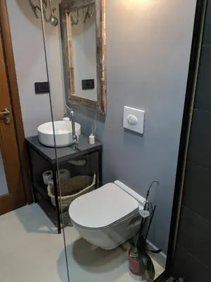 a bathroom with a toilet and a sink and a mirror at Casa Alea in Ulcinj