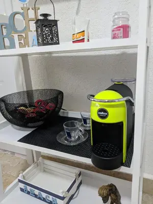 a yellow coffee maker sitting on a shelf at Casa Alea in Ulcinj