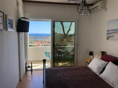 a bedroom with a bed and a view of the ocean at Casa Alea in Ulcinj