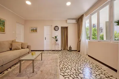 a living room with a couch and a table at Mediterranean vacation home with pool Petrovac in Budva