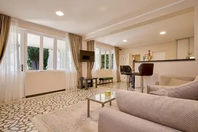 a living room with a couch and a table at Mediterranean vacation home with pool Petrovac in Budva
