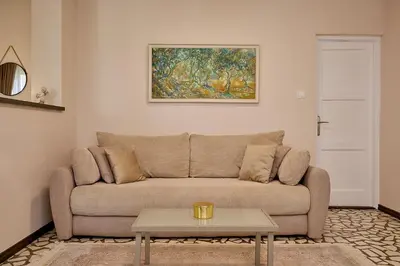 a living room with a couch and a table at Mediterranean vacation home with pool Petrovac in Budva