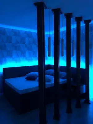 two beds in a room with blue lights at Down Town Studio in Ulcinj
