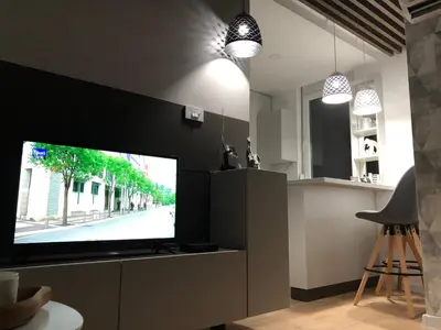 a living room with a flat screen tv on a wall at Down Town Studio in Ulcinj
