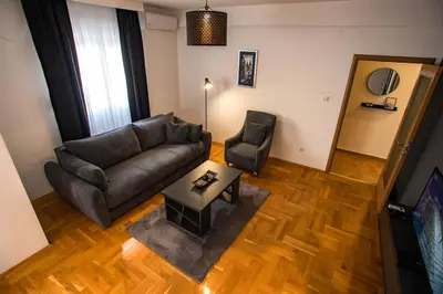 a living room with a couch and a table at Apartment Podgorica in Podgorica