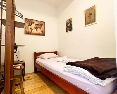 a bedroom with a bed and some pictures on the wall at Old Town Homestel in Kotor