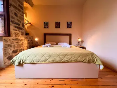 a bedroom with a bed with two lamps on two tables at Old Town Homestel in Kotor