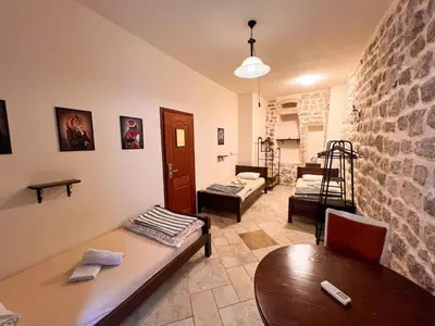 a living room with a table and a couch at Old Town Homestel in Kotor