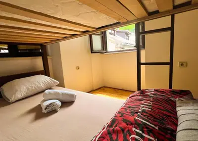 a bedroom with a bed with two towels on it at Old Town Homestel in Kotor