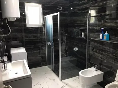 a bathroom with a shower and a toilet and a sink at Adriatic Oasis in Bar