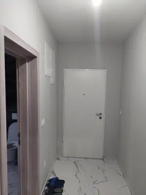 a white room with a white door and a bathroom at Adriatic Oasis in Bar