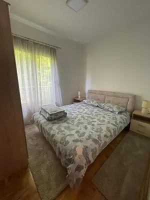 a bedroom with a bed and a large window at Marina in Budva