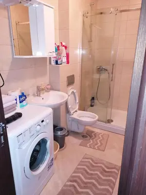 a bathroom with a washing machine and a toilet at Marina in Budva