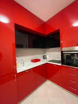 a red kitchen with a sink and a microwave at Marina in Budva