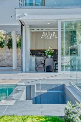 a house with a swimming pool and a dining area at Villa Solaria in Sveti Stefan