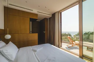 a bedroom with a bed and a large window at Villa Solaria in Sveti Stefan